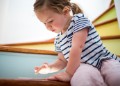 Caucasian girl using digital tablet on staircase